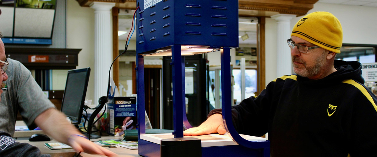 design consultant showing a building material sample under a light