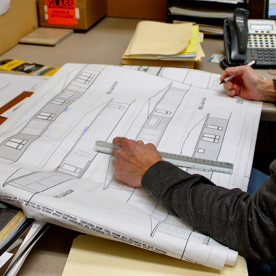 designer looking over blueprints