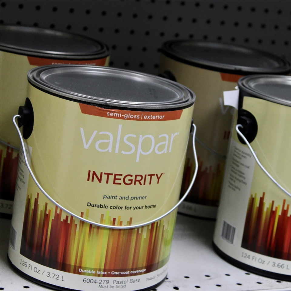 buckets of paint on a shelf