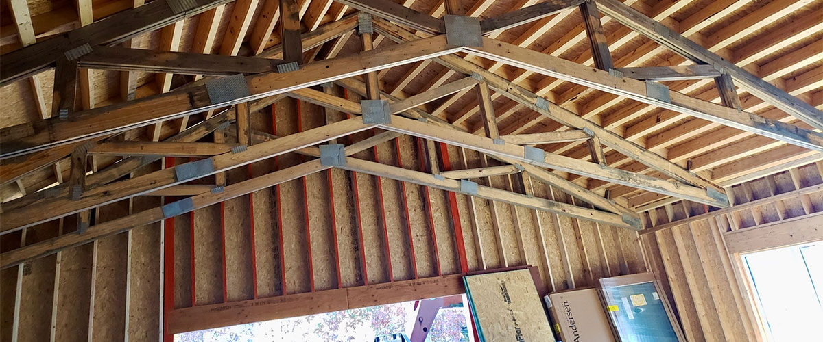 new home construction showing walls, ceiling joists, and roof