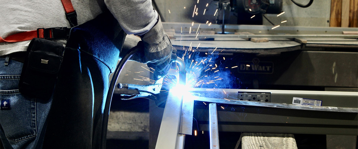 worker welding pieces of metal together