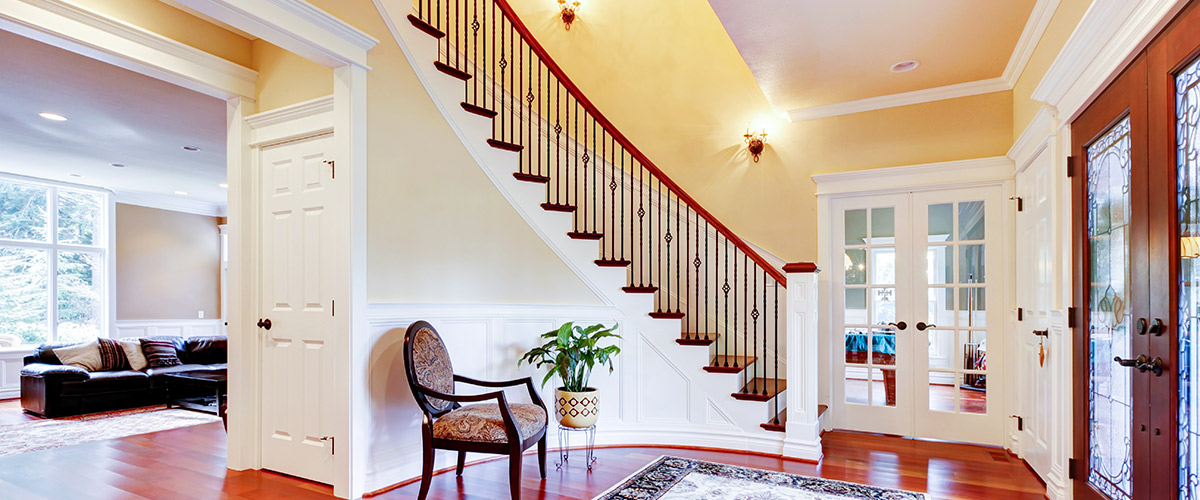 foyer of home with staircase and openings to two rooms