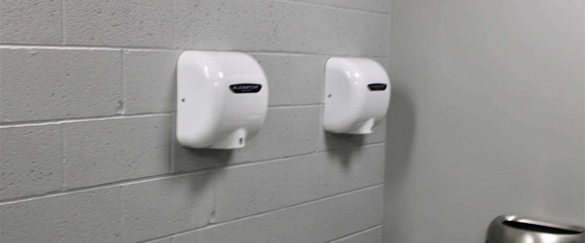 hand dryers hanging on a wall
