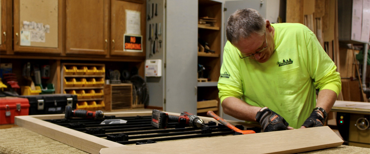 worker framing up a custom wood project